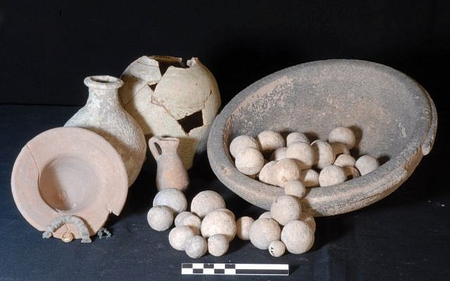 A funerary assemblage with glazed jars, stone weights, bronze fibulae and granulated gold earring from two cremation burials in a pithos in the Outer Town of Karkemish (photo credit: AP Photo/Joint Turco-Italian Archaeological Expedition, File) 