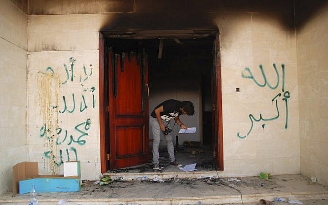 In this Wednesday, Sept. 12, 2012 file photo, a man looks at documents at the U.S. consulate in Benghazi, Libya, after an attack that killed four Americans, including Ambassador Chris Stevens (photo credit: Ibrahim Alaguri)