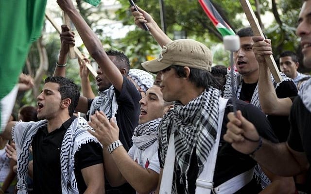 Demonstrators in Caracas, Venezuela shout slogans as they protest Israel's military operations in Gaza on Wednesday (photo credit: AP/Ariana Cubillos) Demonstrators in Caracas, Venezuela shout slogans as they protest Israel's military operations in Gaza on Wednesday (photo credit: AP/Ariana Cubillos)
