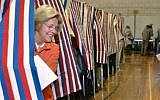 Democratic candidate for US Senate Elizabeth Warren, left, emerges from the polling booth as she votes in Cambridge, Massaschusetts on Election Day. (photo credit: AP/Josh Reynolds)