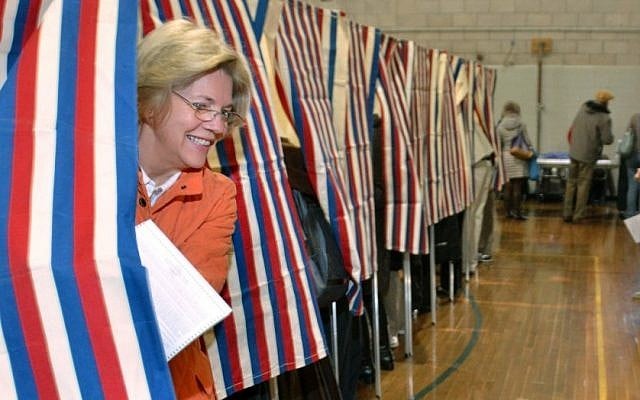 Democratic candidate for US Senate Elizabeth Warren, left, emerges from the polling booth as she votes in Cambridge, Massaschusetts on Election Day. (photo credit: AP/Josh Reynolds)