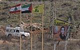 Illistrative: Lebanese, Palestinian and Hezbollah flags on the northern side of Israel's border with Lebanon. (Hamad Almakt/Flash90/File)