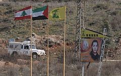 Illistrative: Lebanese, Palestinian and Hezbollah flags on the northern side of Israel's border with Lebanon. (Hamad Almakt/Flash90/File)