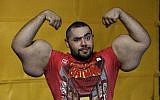 Egyptian Body builder Moustafa Ismail poses during his daily workout at World Gym in Milford, Mass., on Friday, November 16, 2012 (photo credit: AP Photo/Stephan Savoia)