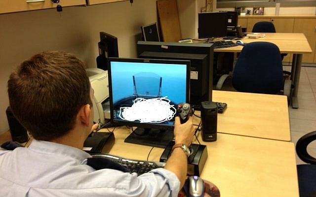 Captain G practicing on a screen that simulates the F-15I cockpit (Photo credit: Mitch Ginsburg/ Times of Israel)