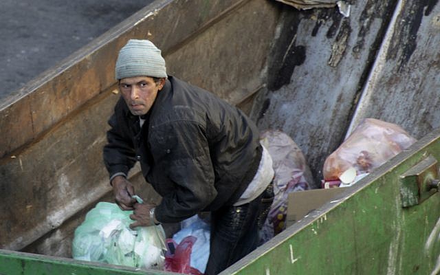 A man searching through garbage in Jerusalem (photo credit: Nati Shohat/Flash90)