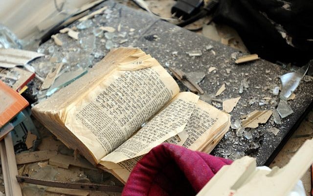 A Bible covered with debris in a Kiryat Malachi apartment in which three people were killed from a rocket attack on Thursday (photo credit: Yossi Zeliger/Flash90) A Bible covered with debris in a Kiryat Malachi apartment in which three people were killed from a rocket attack on Thursday (photo credit: Yossi Zeliger/Flash90)
