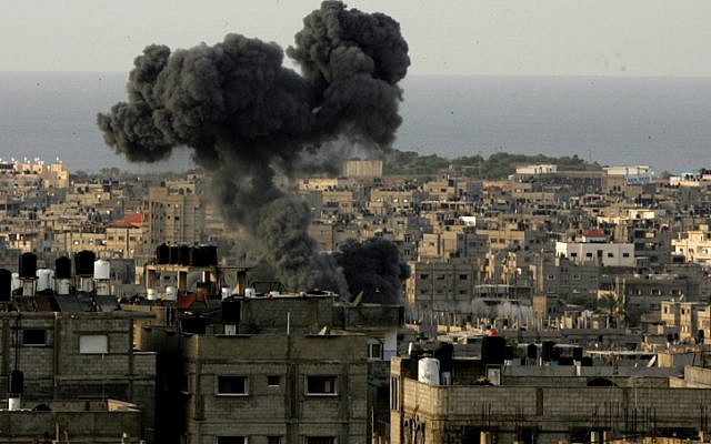 Smoke billows from the site of an Israeli airstrike in the southern Gaza Strip on November 16, 2012. (photo credit: Abed Rahim Khatib/Flash 90) Smoke billows from the site of an Israeli airstrike in the southern Gaza Strip on November 16, 2012. (photo credit: Abed Rahim Khatib/Flash 90)