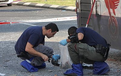 Israeli police and rescue personnel at the scene of a bus bombing on a Tel Aviv passenger bus on Wednesday (photo credit: Roni Schutzer/Flash90)