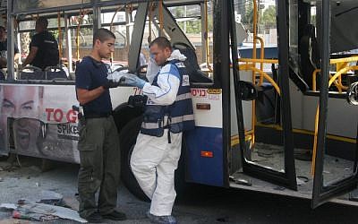 Police and rescue personnel at the scene of the Wednesday, November 21 bus bombing in Tel Aviv (photo credit: Roni Schutzer/Flash90)