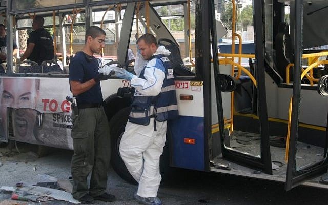 Police and rescue personnel at the scene of the Wednesday, November 21 bus bombing in Tel Aviv (photo credit: Roni Schutzer/Flash90)