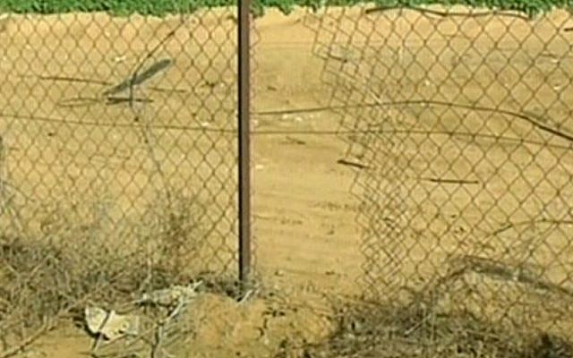 A hole in the fence of a community in the Eshkol region through which a Palestinian attacker entered, Monday (photo credit: Channel 2 screen capture) A hole in the fence of a community in the Eshkol region through which a Palestinian attacker entered, Monday (photo credit: Channel 2 screen capture)