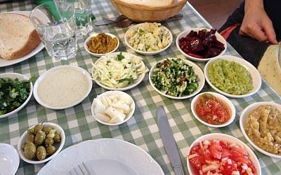 A dazzling array of salads served with a hunk of old-fashioned 'black bread' at Adon Cohen (photo credit: Jessica Steinberg/Times of Israel) A dazzling array of salads served with a hunk of old-fashioned 'black bread' at Adon Cohen (photo credit: Jessica Steinberg/Times of Israel)