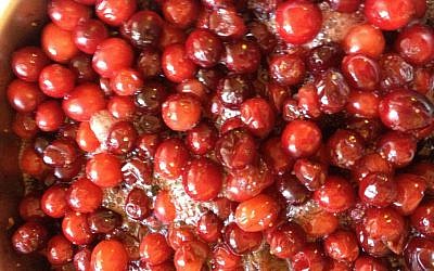 Cranberries bubbling away on the stove (photo credit: Jessica Steinberg/Times of Israel)