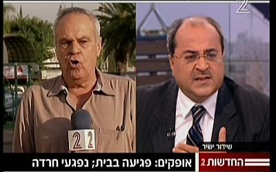 Arab MK Ahmed Tibi lets loose on Channel 2's military analyst Roni Daniel (image capture/Channel 2 News)