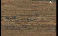 Syrian soldiers firing artillery shells near Israel's border on Monday. (Screenshot/ Channel 2)