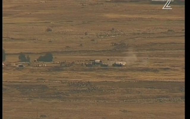Syrian soldiers firing artillery shells near Israel's border on Monday. (Screenshot/ Channel 2)