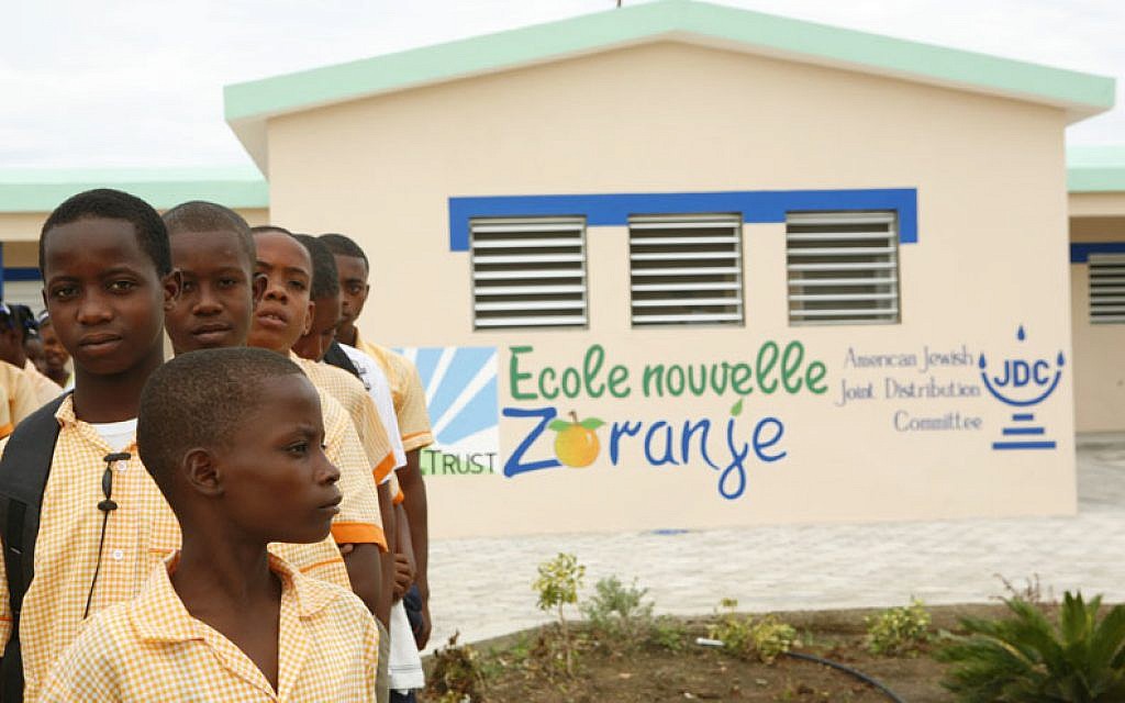 Children from the Haitian town of Zoranje stand outside a school built with part of the $16.2 million donated by Jewish organizations after the deadly 2010 earthquake. (Courtesy of the American Jewish Joint Distribution Committee via JTA)
