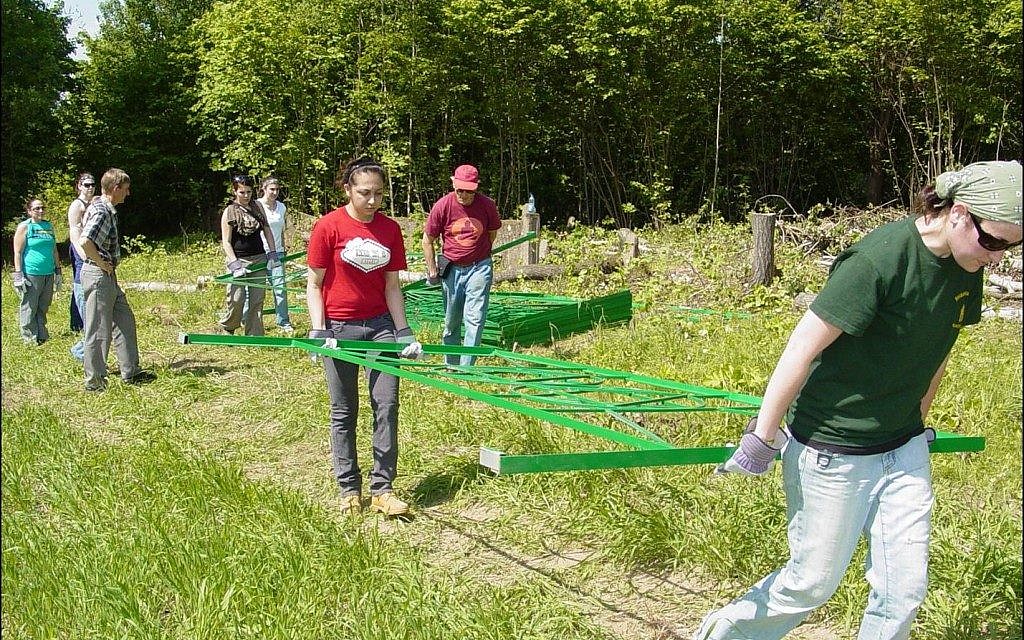 College students, roughly a third of them Jewish, help Lozman place fences around abandoned Jewish graveyards. Many receive course credit for academic work they do to prepare. (Courtesy of Michael Lozman)