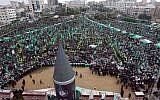 A large model of a M75 long-range missile is seen as hundreds of thousands attend a rally to commemorate the 25th anniversary of the Hamas terrorist organization in Gaza city in December. (photo credit: AP/Hatem Moussa)