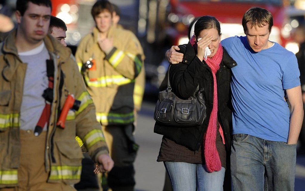 A victim's family leaves a firehouse staging area following a shooting at the Sandy Hook School in Newtown, Connecticut, where authorities say a gunman opened fire, leaving 27 people dead, including 20 children in 2012. (photo credit: AP/Jessica Hill) A victim's family leaves a firehouse staging area following a shooting at the Sandy Hook School in Newtown, Connecticut, where authorities say a gunman opened fire, leaving 27 people dead, including 20 children in 2012. (photo credit: AP/Jessica Hill)