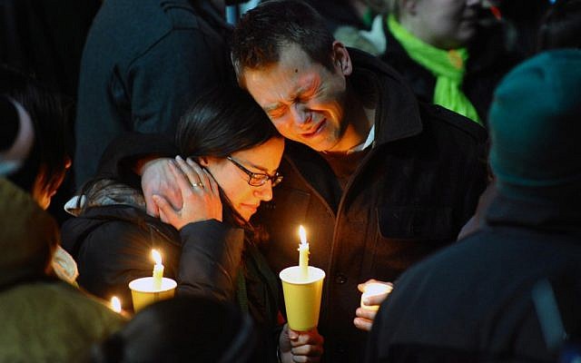 Mourners attend a candlelight vigil held behind Stratford High School on the Town Hall Green in Stratford, Connecticut on Saturday December 15, 2012, remembering victims of the mass shooting at Sandy Hook Elementary School in nearby Newtown. (The Connecticut Post, Christian Abraham/AP) Mourners attend a candlelight vigil held behind Stratford High School on the Town Hall Green in Stratford, Connecticut on Saturday December 15, 2012, remembering victims of the mass shooting at Sandy Hook Elementary School in nearby Newtown. (The Connecticut Post, Christian Abraham/AP)