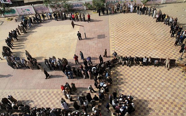 Egyptians wait in line to cast their votes during a referendum on a disputed constitution drafted by Islamist supporters of President Morsi in Cairo, Egypt, Saturday, Dec. 15, 2012. (Photo credit: AP/Ahmed Gomaa) Egyptians wait in line to cast their votes during a referendum on a disputed constitution drafted by Islamist supporters of President Morsi in Cairo, Egypt, Saturday, Dec. 15, 2012. (Photo credit: AP/Ahmed Gomaa)