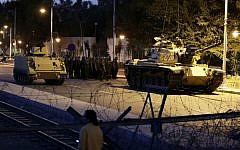 An Egyptian Army tank deploys outside the presidential palace in Cairo on Thursday, December 6, 2012, to control crowds of anti-government protesters (photo credit: AP/Hassan Ammar)