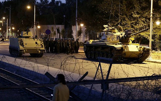 An Egyptian Army tank deploys outside the presidential palace in Cairo on Thursday, December 6, 2012, to control crowds of anti-government protesters (photo credit: AP/Hassan Ammar)