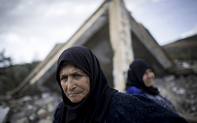 Syrian women amid the ruins of their farm, destroyed by Syrian Army jets (photo credit :Manu Brabo/AP)