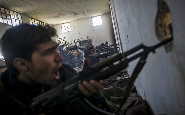 Free Syrian Army fighters aim their weapons as they chant religious slogans during heavy clashes with government forces north of Aleppo, Syria (photo credit: AP/Narciso Contreras) Free Syrian Army fighters aim their weapons as they chant religious slogans during heavy clashes with government forces north of Aleppo, Syria (photo credit: AP/Narciso Contreras)