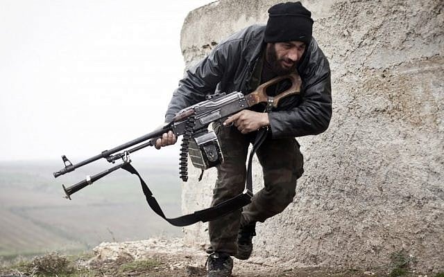 A Free Syrian Army fighter takes cover during fighting with the Syrian Army in Azaz, Syria on Monday. (photo credit: AP/Virginie Nguyen Huang) A Free Syrian Army fighter takes cover during fighting with the Syrian Army in Azaz, Syria on Monday. (photo credit: AP/Virginie Nguyen Huang)