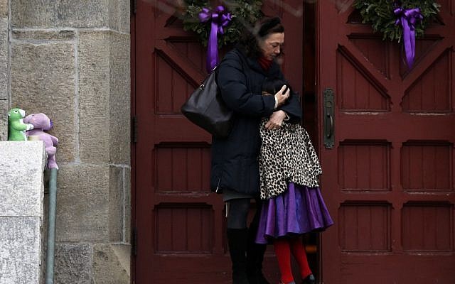 A woman hugs a young girl as they arrive for services at Trinity Church, Sunday, in Newtown, Connecticut (photo credit: AP/Jason DeCrow) A woman hugs a young girl as they arrive for services at Trinity Church, Sunday, in Newtown, Connecticut (photo credit: AP/Jason DeCrow)