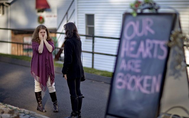 Shop owners Tamara Doherty, left, and Jackie Gaudet, right, meet outside their stores for the first time since being neighbors, just down the road from Sandy Hook Elementary School on Saturday. (photo credit: AP/David Goldman) Shop owners Tamara Doherty, left, and Jackie Gaudet, right, meet outside their stores for the first time since being neighbors, just down the road from Sandy Hook Elementary School on Saturday. (photo credit: AP/David Goldman)