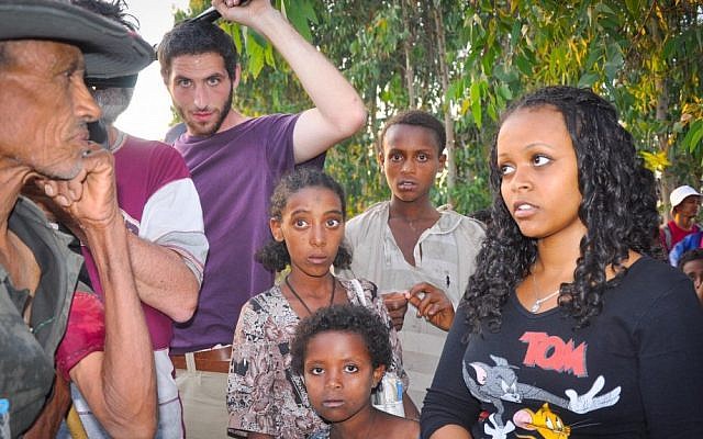 Zahava Aregito Zagaya (right) speaks with Mekdes in Gorgora Buchara, her mother's village. Mekdes said he remembered Zahava's mother and grandparents and showed her here her grandfather was buried. (photo credit: Michal Shmulovich/ToI)
