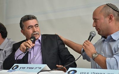 Jewish Home leader Naftali Bennett (right) and Hatnua no. 2 Amir Peretz take part in a panel debate on the Israel-Palestinian conflict, on Sunday, Dec. 23 (photo credit: Dotan Gur/courtesy)