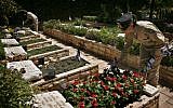 Soldiers place flags on graves at Mount Herzl Military cemetery in Jerusalem to mark Memorial Day in 2012. (photo credit: Michal Fattal/Flash90)