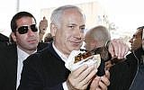 Prime Minister Benjamin Netanyahu enjoying falafel in Acre, December 2012. (photo credit: Michal Fattal/Flash90)