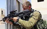 An IDF infantry soldier armed with an Israeli-made Tavor rifle takes part in an urban warfare drill. (Tsafrir Abayov/Flash90)