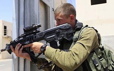 An IDF infantry soldier armed with an Israeli-made Tavor rifle takes part in an urban warfare drill. (Tsafrir Abayov/Flash90)
