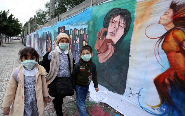 Illustrative. Palestinian schoolchildren wearing protective masks during an outbreak of a virus in 2009 (photo credit: Wissam Nassar/Flash 90)