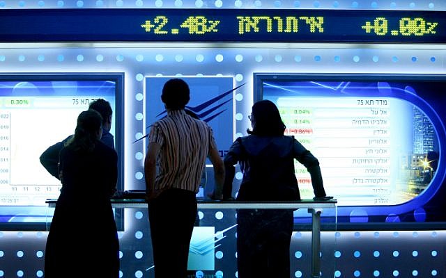 Illustrative: People watch a board showing price fluctuations at the Tel Aviv stock exchange. (Moshe Shai/FLASH90) Illustrative: People watch a board showing price fluctuations at the Tel Aviv stock exchange. (Moshe Shai/FLASH90)