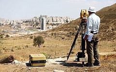 An engineer surveys Har Homa. (photo credit: Abir Sultan/Flash90)
