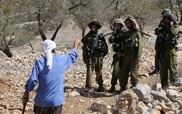 Israeli soldiers confront a Palestinian near the settlement of Yitzhar in September 2010 (photo credit: Wagdi Ashtiyeh/Flash90)