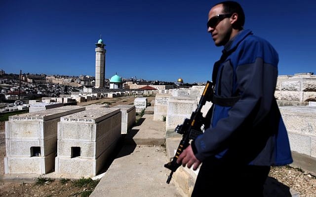 A security guard patrols the Mount of Olives in Jerusalem during a ministerial visit. (photo credit: Abir Sultan/Flash90) A security guard patrols the Mount of Olives in Jerusalem during a ministerial visit. (photo credit: Abir Sultan/Flash90)