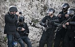 A photojournalist takes a photo of riot policemen during clashes in east Jerusalem in February of 2011. (Illustrative photo: Ruben Salvadori/Flash 90)