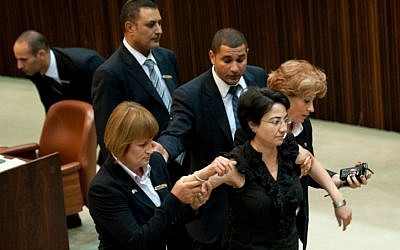 Balad MK Hanin Zoabi is escorted out of the Knesset after a violent outburst during a plenum session on July 13, 2011. (photo credit: Omer Miron/Flash90)