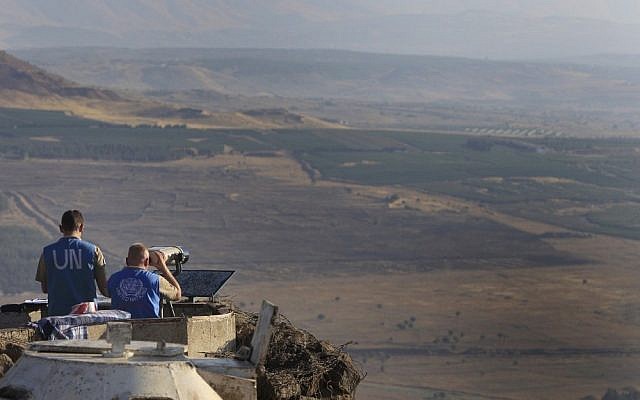 UN peacekeepers monitor the Syrian side of the Israeli-Syrian border from an army post at Mount Bental in the Golan Heights last July (photo credit: Tsafrir Abayov/Flash90) UN peacekeepers monitor the Syrian side of the Israeli-Syrian border from an army post at Mount Bental in the Golan Heights last July (photo credit: Tsafrir Abayov/Flash90)