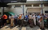 People waiting in line for food packages at a distribution center for needy in Lod on September 11, 2012.  (photo credit: Yonatan Sindel/Flash90)