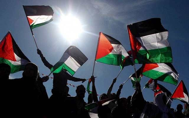 Palestinians wave their national flag during a celebration rally marking the UN General Assembly's upgrading of the Palestinians' status from 'observer entity' to 'nonmember state,' in the West Bank city of Ramallah, December 2, 2012 (photo credit: Issam Rimawi/Flash90) Palestinians wave their national flag during a celebration rally marking the UN General Assembly's upgrading of the Palestinians' status from 'observer entity' to 'nonmember state,' in the West Bank city of Ramallah, December 2, 2012 (photo credit: Issam Rimawi/Flash90)